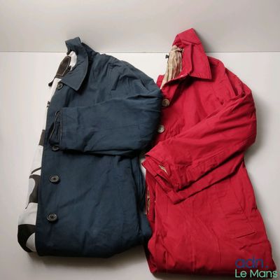 two jackets that are sitting next to each other on a table