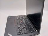 a laptop computer sitting on a table with a keyboard