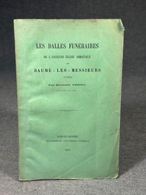 a green book sitting on top of a table next to a black background