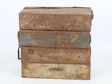 three old metal boxes stacked on top of each other on a white surface