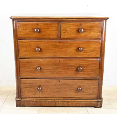 a wooden chest of drawers with a marble top