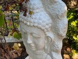 a statue of a woman with a hat on it