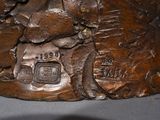 a close up of a statue of a bear on a rock