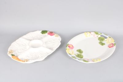 two plates with flowers on them sitting on a gray surface