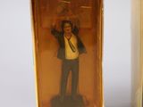 a figurine of a man in a suit and tie in a box