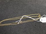 a close up of a gold chain with a tag on it