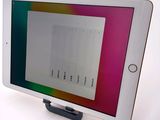 tablet computer with a display on top of it sitting on a table