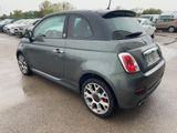 a small grey car parked in a parking lot