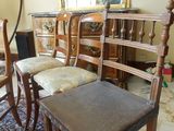 four chairs and a table in a room