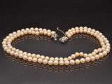 a single strand of pearl necklace and earring set