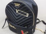 black quilted backpack with gold zippers and chain strap