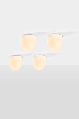 three light fixtures on a white surface with a white background