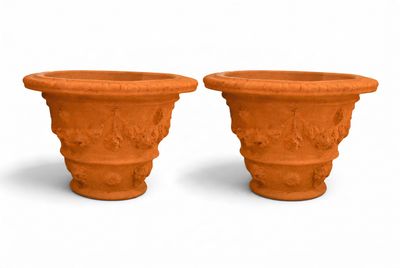 two clay pots sitting next to each other on a white surface