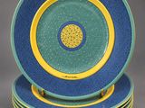 four blue and yellow plates stacked on top of each other