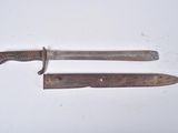 two old knives that are laying on a white surface
