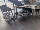 a desk and chairs in a room with a staircase