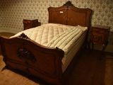 a bed that is in a room with a wallpapered wall