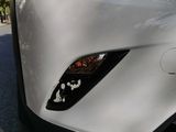 a close up of a car ' s front bumper with a sticker on it