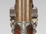 a wooden and metal candle holder with a candle on it