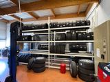 many tires stacked on the shelves in the garage