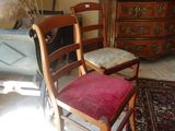 a chair that is sitting in a room with a rug on the floor