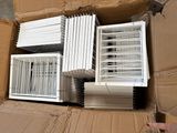 many air conditioners in a cardboard box on the floor