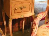 two chairs and a table with a vase on top of it
