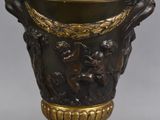 a very large vase with a gold decoration on it