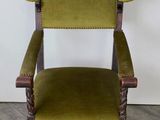 an old wooden chair with green upholstered upholstered seat
