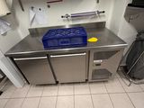 a kitchen with stainless steel cabinets and blue bins on the counter