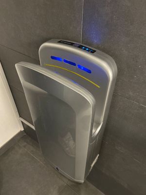 a urinal with a blue light on it in a bathroom