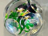 a glass ball with a bunch of flowers inside of it