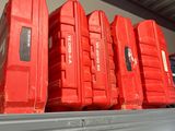 many red boxes sitting on a shelf in a store