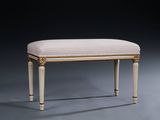 an upholstered foot stool with a beige upholstered seat