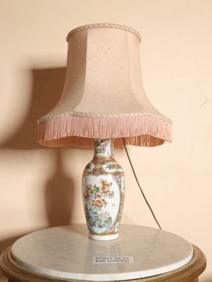 a lamp that is on a table with a lamp shade on it