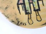 a plate with a painting of a woman sitting on a chair