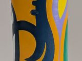 yellow vase with blue and purple designs on it