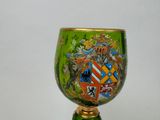 a green vase with a coat of arms painted on it