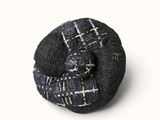 an image of a black and white pin with a blue and white design