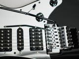 a black and white electric guitar with a skull on it