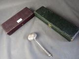 a silver spoon and a box on a table