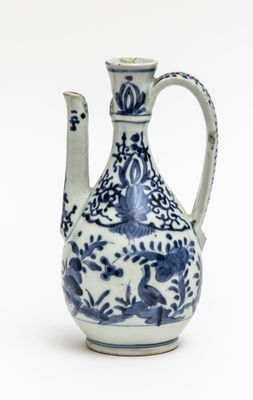 a blue and white vase with a bird design on it