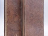 an image of a brown leather book with two pages open