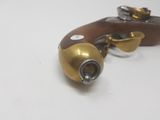 pair of antique brass and wood pistols on a white surface