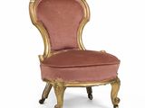 une chaise ancienne avec une assise rembourrée rose et des finitions dorées