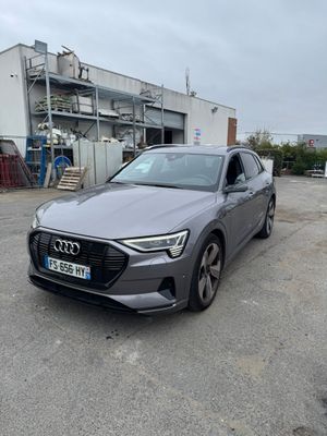 the audi e - trc is parked in front of a building