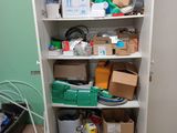 a closet with a lot of boxes and boxes on the shelves