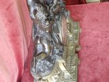 a statue of a man and woman sitting on a bench