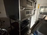 an image of a commercial kitchen with a stove and oven