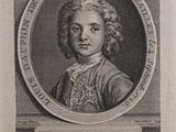 portrait of a young man with curly hair and a white collared shirt